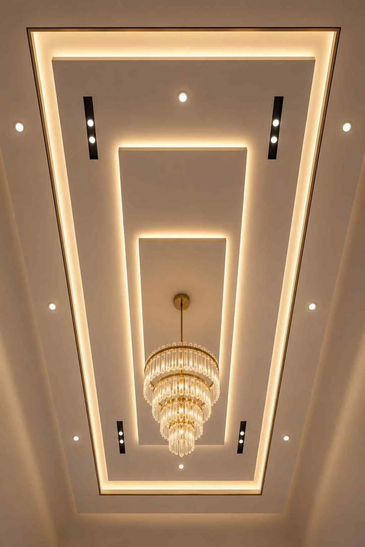 Layered rectangular false ceiling centred around a crystal chandelier