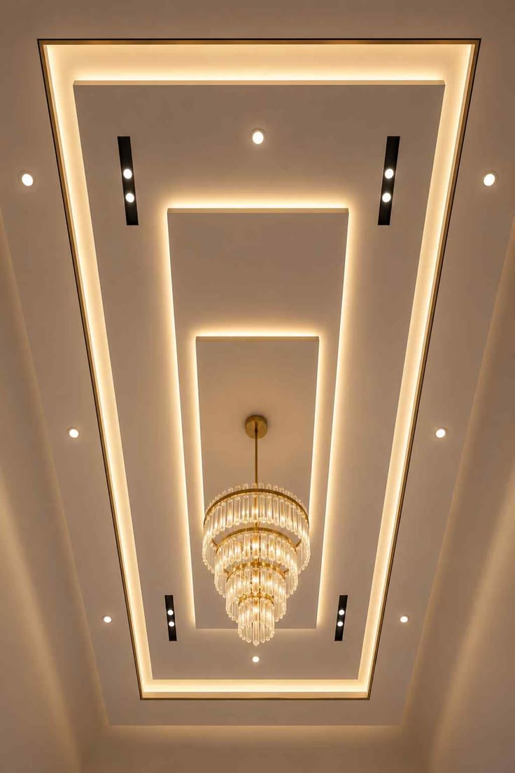 Layered rectangular false ceiling centred around a crystal chandelier