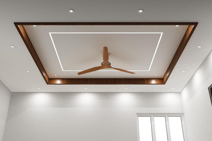 White gypsum false ceiling with a wooden tray border and ceiling fan