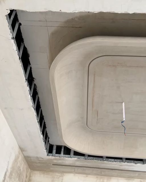 Decorative POP false ceiling with rounded moulded profiles under construction