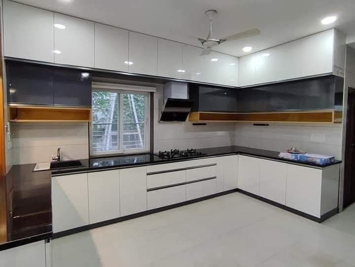 Completed white and charcoal L-shaped modular kitchen